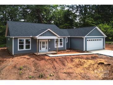 Charming single-story home with gray siding, white trim, and a welcoming front porch at 415 Dogwood Ln, Statesville, NC 28625