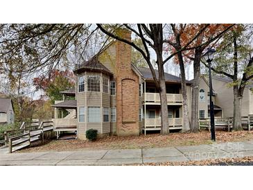 Inviting multi-level condo with brick chimney and private balconies surrounded by mature trees and fall foliage at 6020 Gray Gate Ln # I, Charlotte, NC 28210