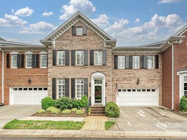 Charming brick townhome with black shutters, well-maintained landscaping, and a welcoming entrance at 6309 Wakehurst Rd, Charlotte, NC 28226
