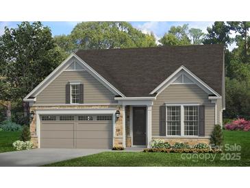 Charming one-story home featuring stone accents, a two-car garage, and manicured landscaping at 7324 Jolly Brook Dr, Charlotte, NC 28215