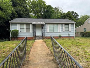 Charming single-story home featuring a well-maintained front yard and classic architectural details at 1101 Mona Dr, Charlotte, NC 28206