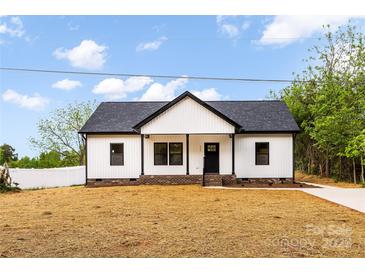 Charming single-story home boasts a newly installed roof and freshly painted white siding at 605 Stirewalt Rd, China Grove, NC 28023
