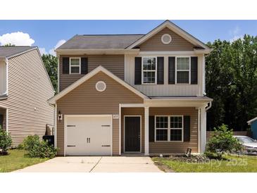 Charming two-story home featuring a one-car garage and welcoming front porch at 6717 Ware Rd, Charlotte, NC 28212
