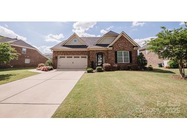 Charming single-Gathering home boasts manicured lawn and a two-car garage, creating an inviting curb appeal at 9026 Raven Top Dr, Mint Hill, NC 28227