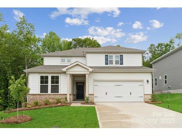 Charming two-story home with a well-manicured lawn, inviting entrance, and a two-car garage at 9956 Manor Vista Trl, Kannapolis, NC 28027