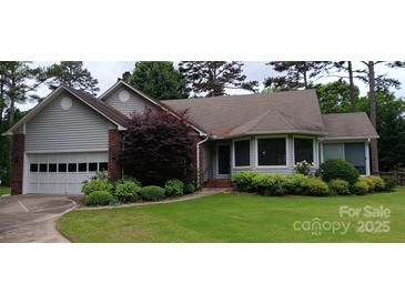 Charming single-story home featuring well-maintained landscaping and attached two-car garage at 104 Gallarie Pl, Salisbury, NC 28144