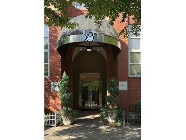 Exterior of brick building featuring covered entrance and stainless steel doors, complemented by decorative planters at 1320 Fillmore Ave, Charlotte, NC 28203