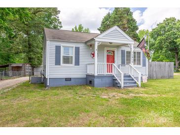 Charming single-story home with a quaint front porch and red front door at 1415 Midlake Rd, Kannapolis, NC 28083