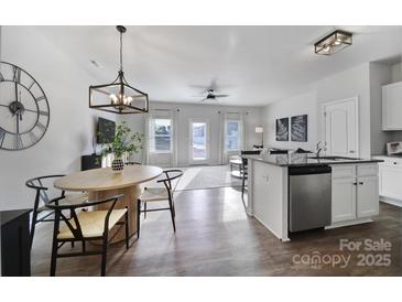 Bright, open concept living room and kitchen area with stainless steel appliances and a dining area with seating at 177 Briana Marie Way, Indian Trail, NC 28079