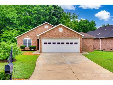 Charming single-story brick home featuring a two-car garage and well-maintained landscaping at 1866 Charter Dr, Rock Hill, SC 29732