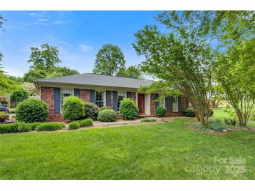 Charming brick ranch home with manicured lawn and mature trees at 1940 12Th Ne St, Hickory, NC 28601