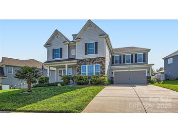 Charming two-story home featuring stone accents, gray siding, and a well-manicured lawn with a concrete driveway at 2322 Tessa Trce, Clover, SC 29710