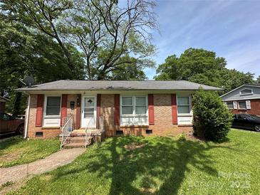 Charming brick home with red shutters, a well-manicured lawn, and a inviting front entrance at 3720 Blandwood Dr, Charlotte, NC 28217