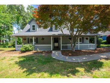 Charming home featuring a welcoming front porch and mature landscaping at 4516 Kiser Island Rd # 1, Terrell, NC 28682