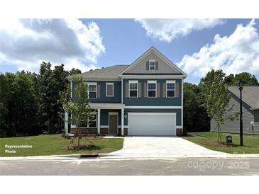 Inviting two-story home boasts a well-manicured lawn and a charming facade with a two-car garage at 6443 Honor Ave, Midland, NC 28107