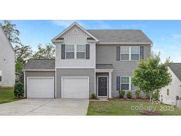 Charming two-story home featuring a two-car garage, gray siding, shutters, and a well-manicured front lawn at 165 Clove Hitch Dr # I281, Statesville, NC 28677