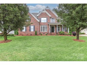 Traditional brick home with a well-manicured lawn and mature landscaping, perfect for curb appeal at 212 Forest Walk Way, Mooresville, NC 28115