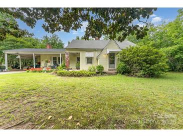 Charming home with a covered carport, complemented by mature trees and vibrant landscaping at 2556 Salem Church Rd, Lincolnton, NC 28092