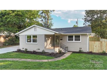 Charming single-story home featuring freshly painted brick, new landscaping, and a welcoming front porch at 4042 Uppergate Ln, Charlotte, NC 28215