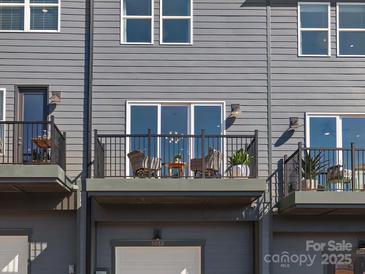 A stylish balcony features a seating area with a small table, perfect for relaxing outdoors at 5512 Swaling St, Charlotte, NC 28217