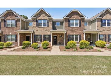 Charming townhome with brick facade, black shutters, manicured landscaping, and a welcoming entrance at 6315 Prosperity Church Rd, Charlotte, NC 28269