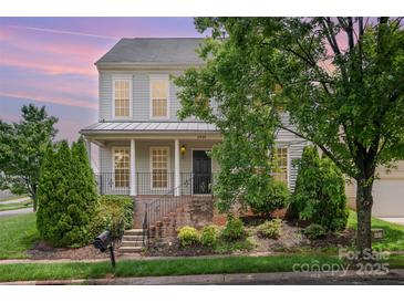 Charming two-story home with manicured landscaping, inviting front porch, and classic architectural details at 6948 Church Wood Ln, Huntersville, NC 28078