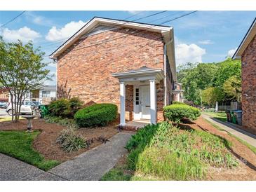 Charming brick home featuring a covered front entrance with white columns and well-maintained landscaping at 862 Mcalway Rd, Charlotte, NC 28211