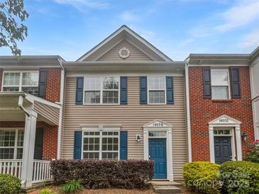 Charming townhome with a well-maintained facade, featuring blue shutters and a quaint front garden at 14056 Lyon Hill Ln, Huntersville, NC 28078