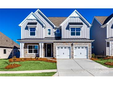 Charming two-story home featuring stone accents, a two-car garage, and well-maintained landscaping at 18011 Wilbanks Dr, Charlotte, NC 28278