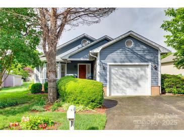 Charming blue house with a well-manicured lawn, attached garage, and inviting curb appeal at 2915 Cherry Blossom Ct, Fort Mill, SC 29715