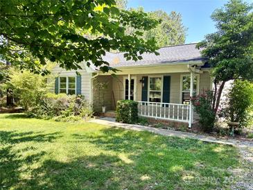 Charming single-story home with a cozy front porch and mature landscaping at 401 Overlook Dr, Monroe, NC 28110