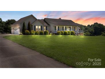Inviting one-story home with manicured lawn and charming front porch, perfect for relaxing evenings at 4916 Ritchie Rd, Lincolnton, NC 28092