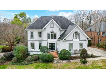 Charming two-story home featuring a well-manicured lawn and a classic architectural design with neutral colors at 520 Beacon Knoll Ln, Fort Mill, SC 29708
