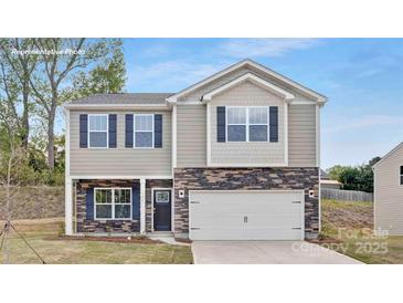 Charming two-story home featuring stone accents and a welcoming two-car garage at 5540 Pamplona Way, Charlotte, NC 28214