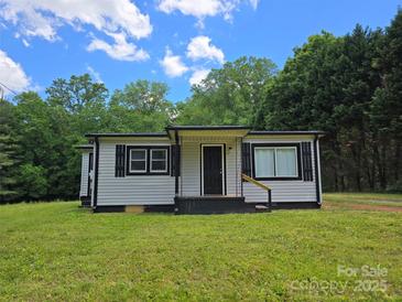 Charming single-story home featuring gray siding, black shutters, and a well-maintained lawn at 1150 Shue Rd, China Grove, NC 28023