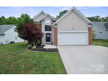 Charming single-Gathering home featuring a well-manicured lawn and an attached two-car garage at 16337 Greybriar Forest Ln, Charlotte, NC 28278