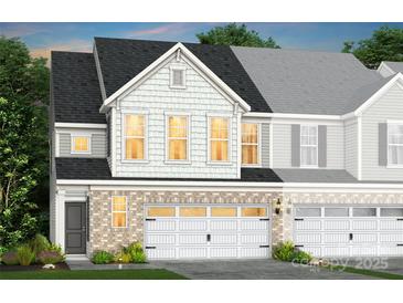Charming townhouse with brick facade, white garage doors, and varied siding textures at 2215 Cobble Ct # 215, Monroe, NC 28110