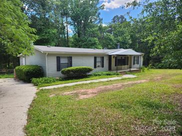 Charming single-story home with a well-maintained lawn and mature trees providing shade at 269 Saddle Rd, Lancaster, SC 29720