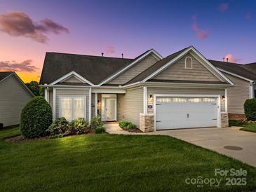 Charming single-Gathering home with a two-car garage, lush lawn, and welcoming curb appeal at dusk at 301 Garner Dr, Salisbury, NC 28146