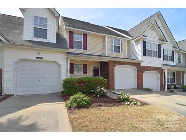 Charming townhome featuring a one-car garage, neutral siding, and well-maintained landscaping, enhancing curb appeal at 3050 Des Prez Ave, Fort Mill, SC 29707