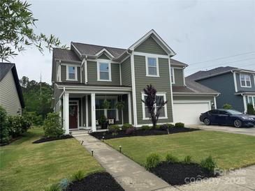 Charming two-story home with a well-manicured lawn and inviting front porch at 155 Boxelder Rd, Clover, SC 29710