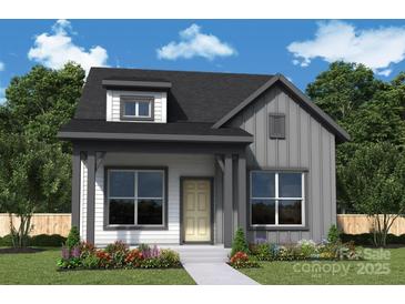 Charming home showcasing board and batten siding, stylish dormer, covered porch, and professional landscaping at 17033 Malone Ln, Mint Hill, NC 28227