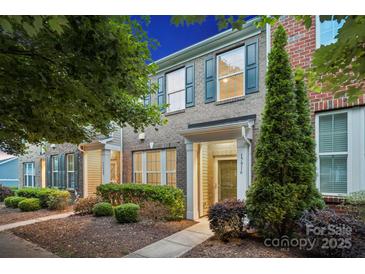 Charming brick townhome with well-maintained landscaping and inviting entrance at 17916 Ragtop Day Ln, Cornelius, NC 28031