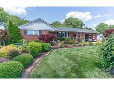 Well-maintained lawn and beautiful landscaping enhance this charming brick home's curb appeal at 3008 Imperial Dr, Gastonia, NC 28054