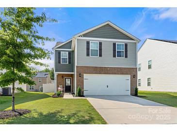 Charming two-story home featuring a two-car garage, well-maintained lawn, and inviting curb appeal at 446 Misty Law Ln, Clover, SC 29710