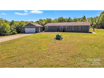 Charming single story home with detached garage and spacious green front yard at 725 Hunters Ridge Rd, Taylorsville, NC 28681