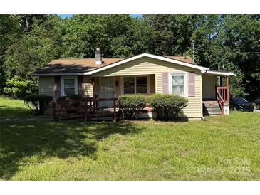 Charming single-story home featuring a quaint porch and well-maintained front yard at 910 Absher Rd, Statesville, NC 28625