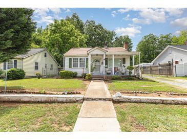 Charming bungalow with a quaint front porch, and a well maintained yard at 1308 Edgewood Rd, Charlotte, NC 28208