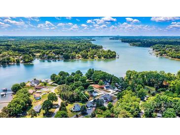 Stunning aerial view of a lakefront property surrounded by lush greenery and sparkling blue waters at 139 Elysian Dr, Mooresville, NC 28117