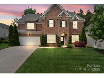Beautiful two-story brick home featuring a well-manicured lawn and an attached two-car garage at 15247 Prescott Hill Ave, Charlotte, NC 28277